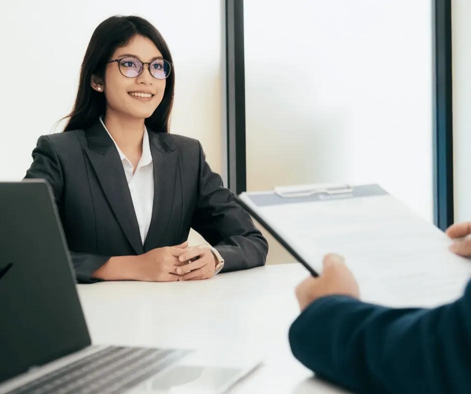 Professional refining a resume with market data dashboards open.