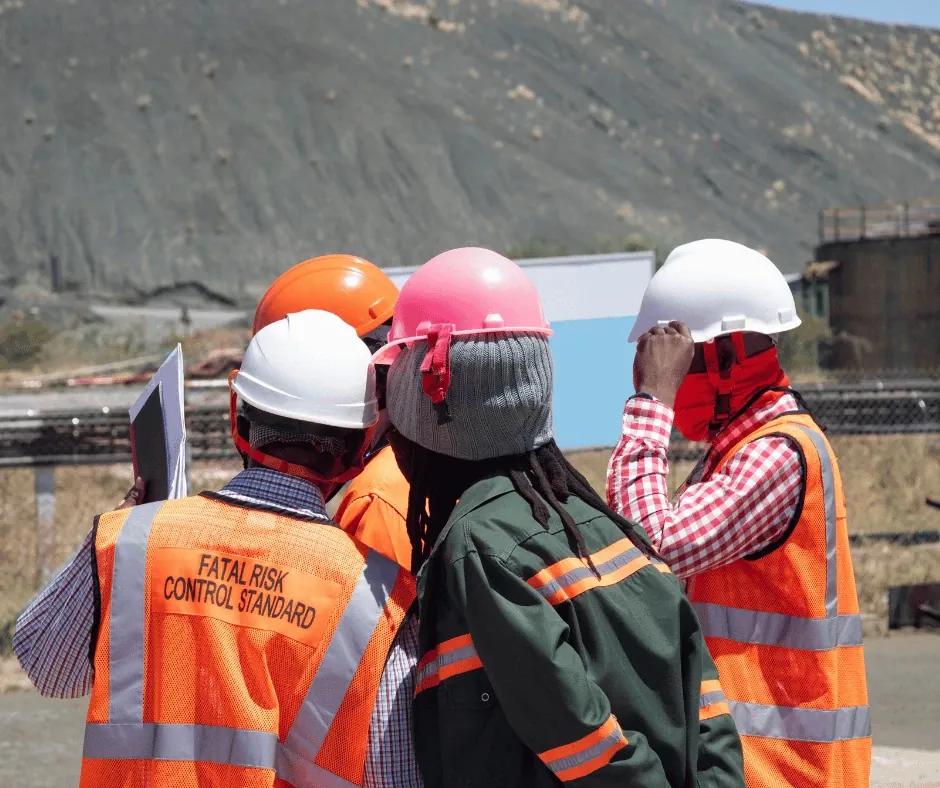 Project coordinator reviewing construction site plans.